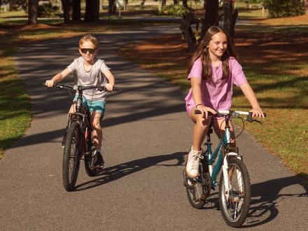 Kids biking along the paved trails in Gulf State Park in Gulf Shores