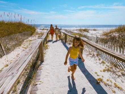 Family walking on path from the beach