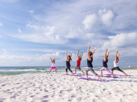 Women doing yoga on the beach in Gulf Shores