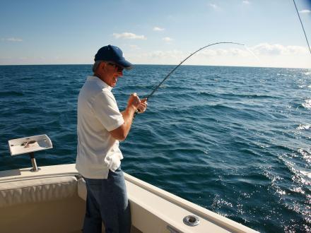 angler hold a rod on an offshore charter boat in the Gulf