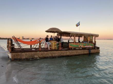 Group of people relaxing on a Hammock Time Tiki Tour cruise in Orange Beach