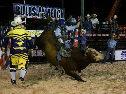 Cowboy riding a bull at Flora-Bama's Bull on the Beach rodeo