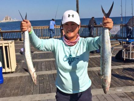 woman holding mackerel caught at The Gulf State Park Fishing Pier in Gulf Shores