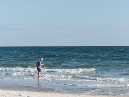 Angler surf fishing on the beach in Gulf Shores