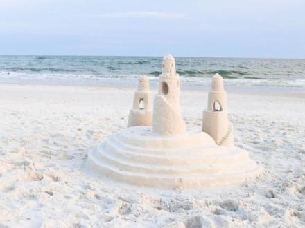 Intricate sandcastle built on the beach by Sand Castle University