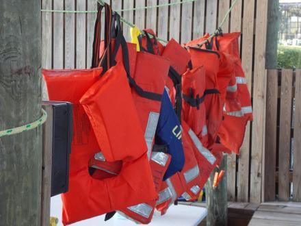 life jackets hung up at a marina