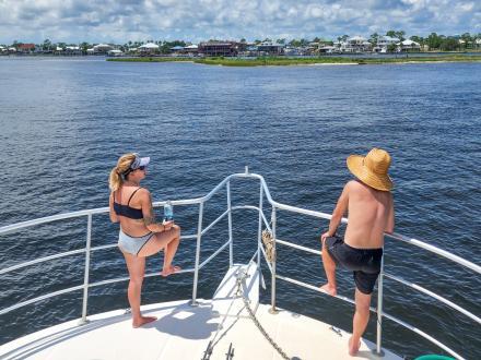 people on a boat cruising through the back bays