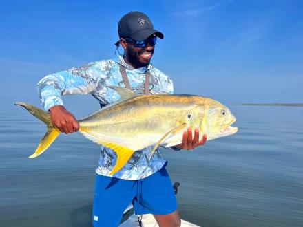 angler holding a jack crevalle caught in the Gulf in Orange Beach