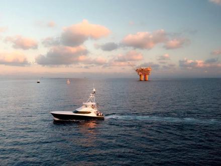 Southern Charm Orange Beach charter boat heading offshore during sunset