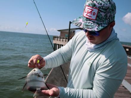 Man showing off his catch at the Gulf State Park Fishing Pier in Gulf Shores