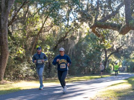 Participants of the Coastal Half Marathon running along the trail in Gulf State Park
