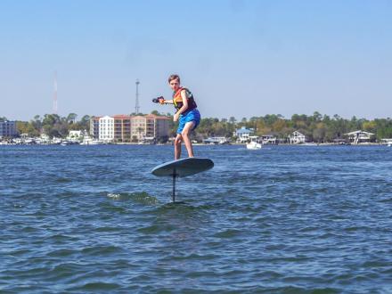 boy foilboarding in the bays in Orange Beach