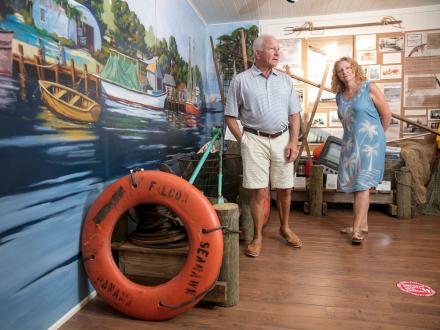 Couple admiring the coastal exhibits inside the Gulf Shores Museum
