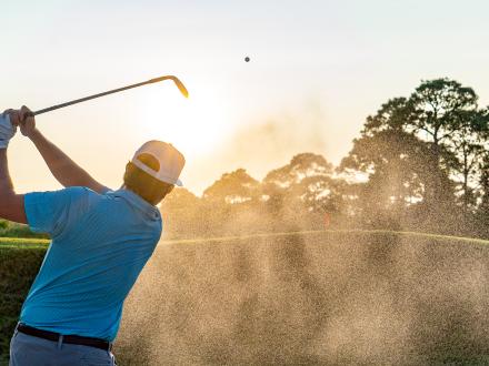 A snowbird golfing and enjoying the mild temperatures during an Alabama's Beaches winter