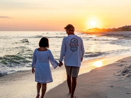 Couple walking along the beach at sunset