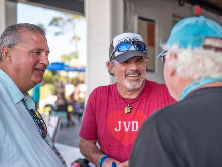 Three snowboarding friends connecting while at a local restaurant in Gulf Shores