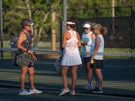 Tennis players chatting on the court at the Gulf Shores tennis courts