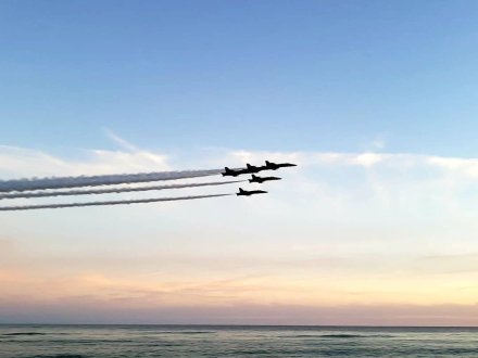 blue angels flying over the gulf at sunset