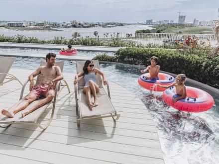 Family enjoying the rooftop lazy river at The Caribe waterfront resort in Orange Beach