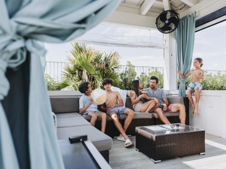 Family in a poolside cabana at The Caribe Resort in Orange Beach
