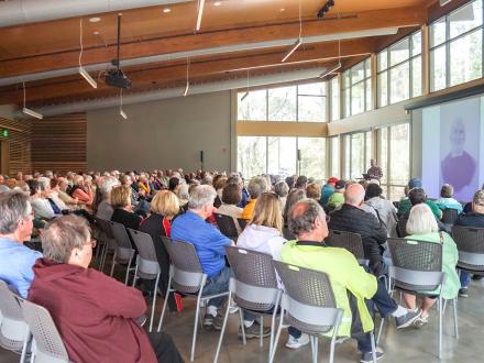 Snowbirds learning and listening to a speaker at a Winter Showcase Series presentation on Alabama's Beaches