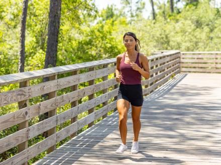 Woman running along the trails in Gulf State Park in Gulf Shores