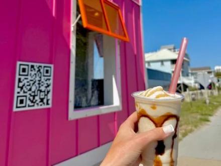 hand holding a peanut butter bushwacker at high tide daiquiris & mimosas 3 in gulf shores