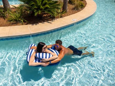 Couple floating along the lazy river at Phoenix Orange Beach condo
