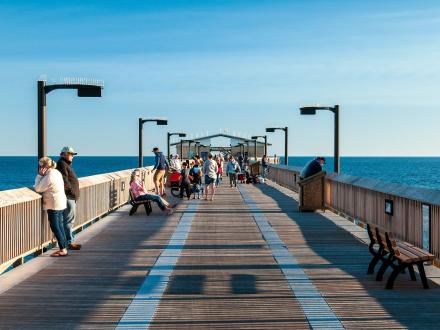 Sightseers and anglers along the Gulf State Park Fishing Pier in Gulf Shores