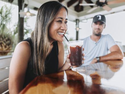 Woman enjoying her bushwacker on Alabama's Beaches