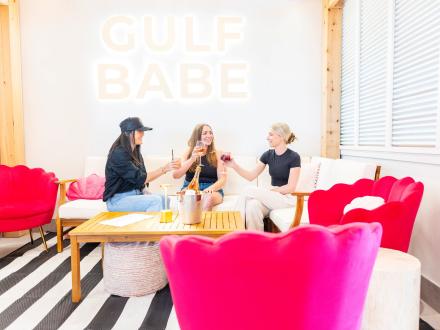 Girls sipping cocktails at Gulf Babe Wine Boutique at the Wharf