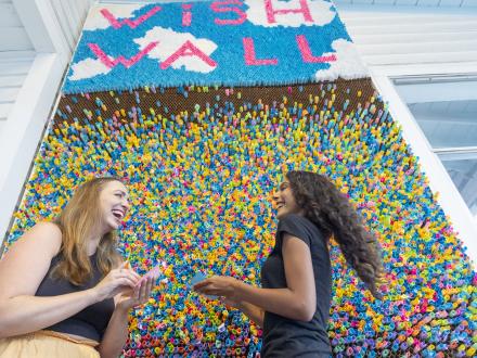 girlfriends at the colorful wish wall at the hangout, beachfront restaurant