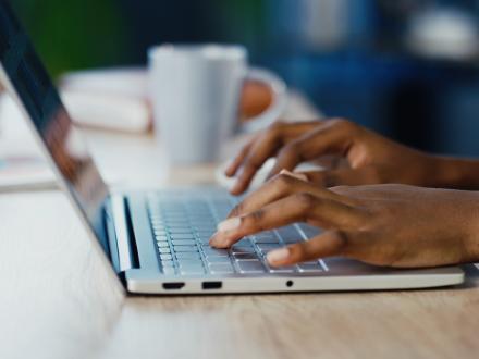 hands typing on a laptop