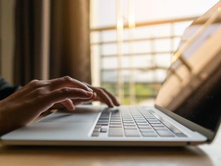 hand typing on laptop