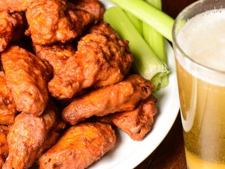 Buffalo chicken wings, celery, and a pint of beer