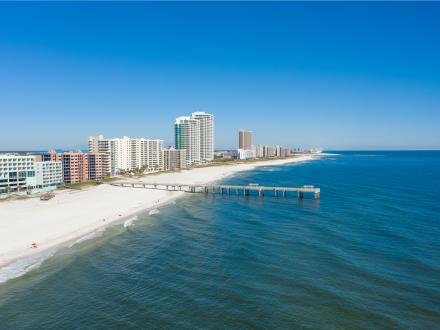 Aerial view of white sand shores and turquoise waters of Orange Beach
