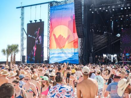 Crowd enjoying live music from a beachfront stage at Hangout Music Festival in Gulf Shores