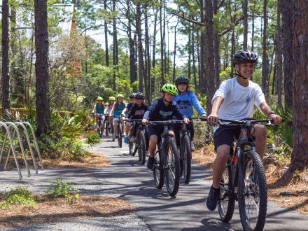 Visitors riding bikes through the eco-center campus