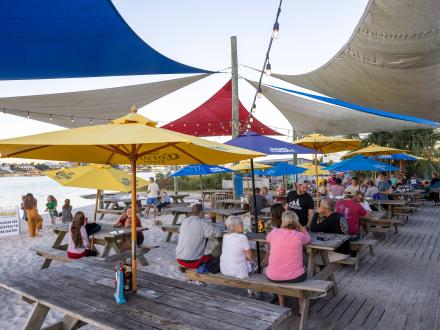 Picnic tables at Flora-Bama Yacht Club waterfront restaurant