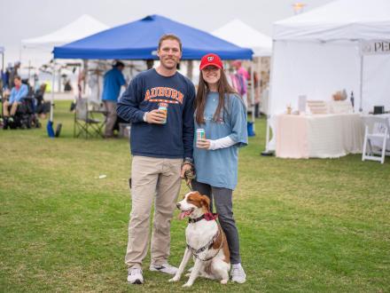 Couple with dog at the Coastal Alabama Food Truck & Craft Beer Festival in Gulf Shores