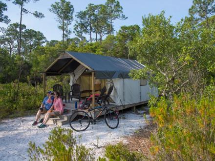 Couple camping at The Outpost primitive camp sites in Gulf State Park
