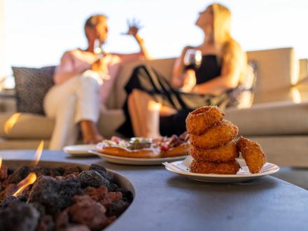 Couple dining on the porch at Perch fine dining restaurant in Gulf Shores