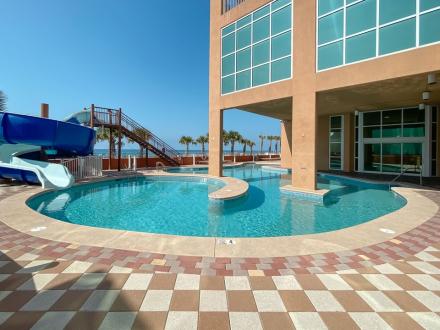 Beachfront pool and waterslide at Phoenix Gulf Shores condo in Gulf Shores