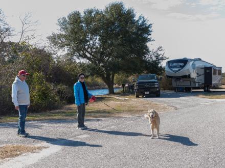 Snowbirds walking their dog at their campground site on Alabama's Beaches