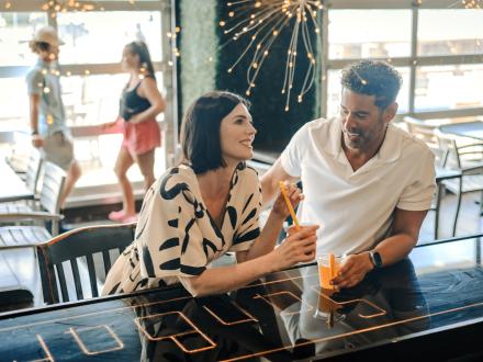 couple sipping drinks at the bar at San Bar at The Wharf