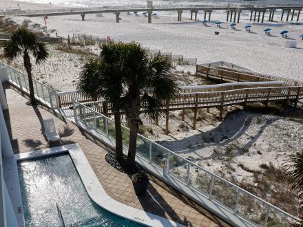 View of pool, boardwalk, and beach from the lobby at The Tides beachfront hotel in Orange Beach