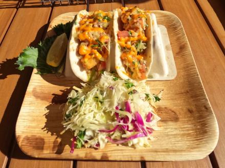 Plate of fresh shrimp tacos and coleslaw at Coastal beachfront restaurant in Orange Beach