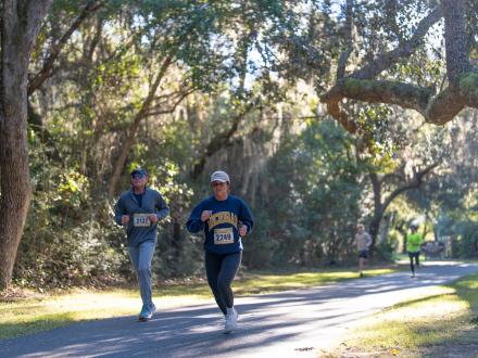 Runners racing along the paved trails in Gulf State Park in Orange Beach