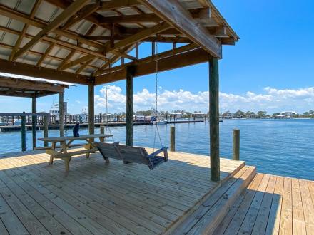 Private pier and boat dock at Dunrobin Cottage vacation rental in Orange Beach