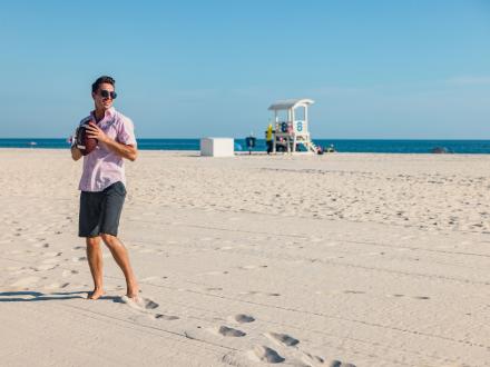 Guy about to throw a football on the beach in Gulf Shores